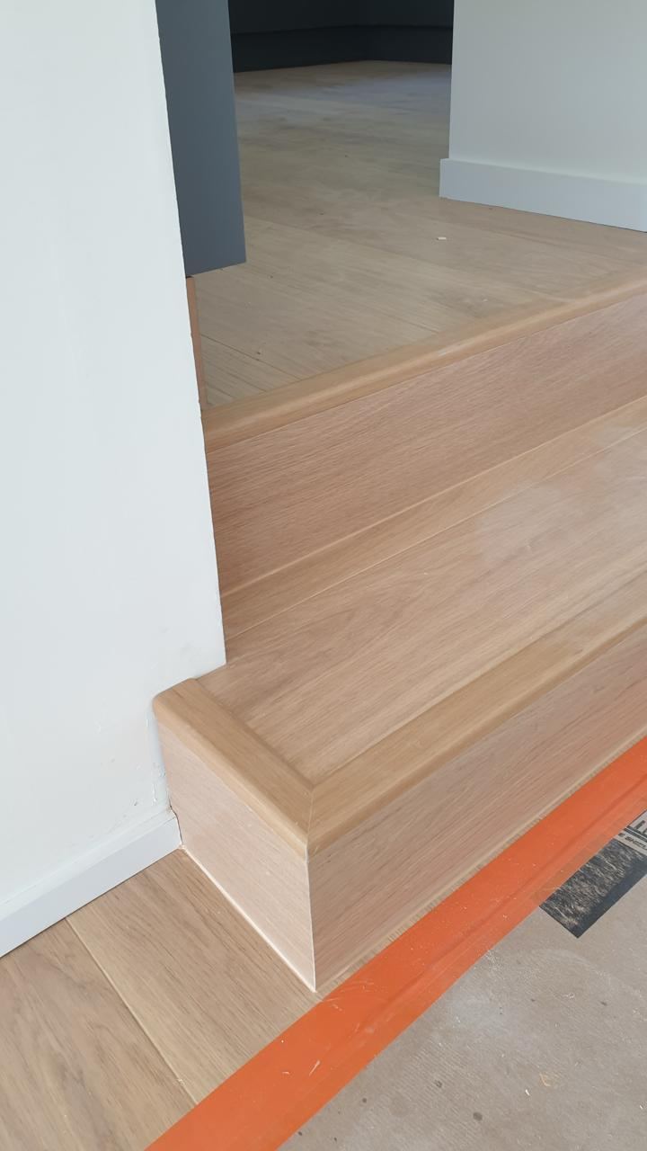 Timber flooring wrapping neatly around a stair landing
