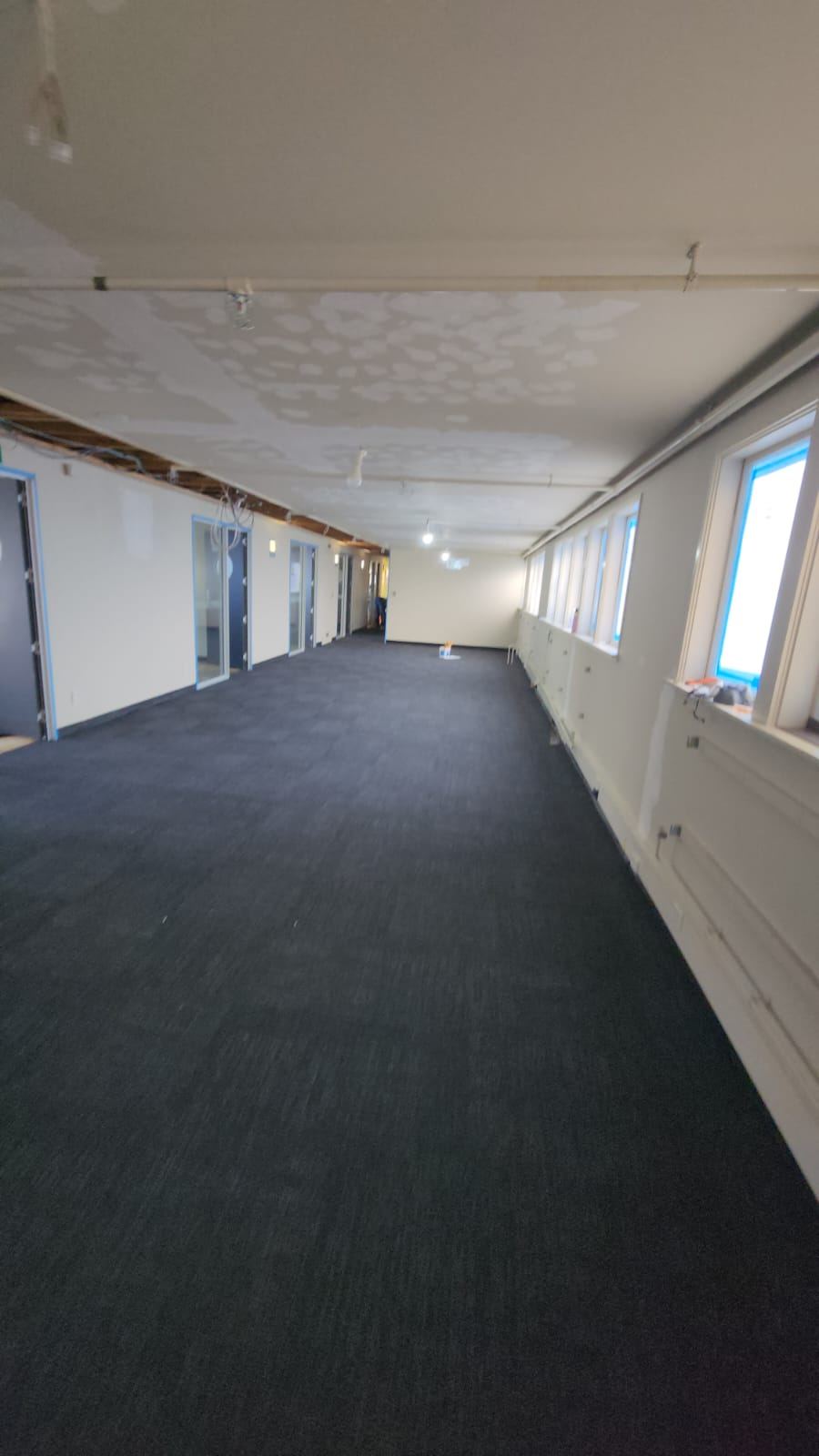 After: the finished carpet-tiled corridor