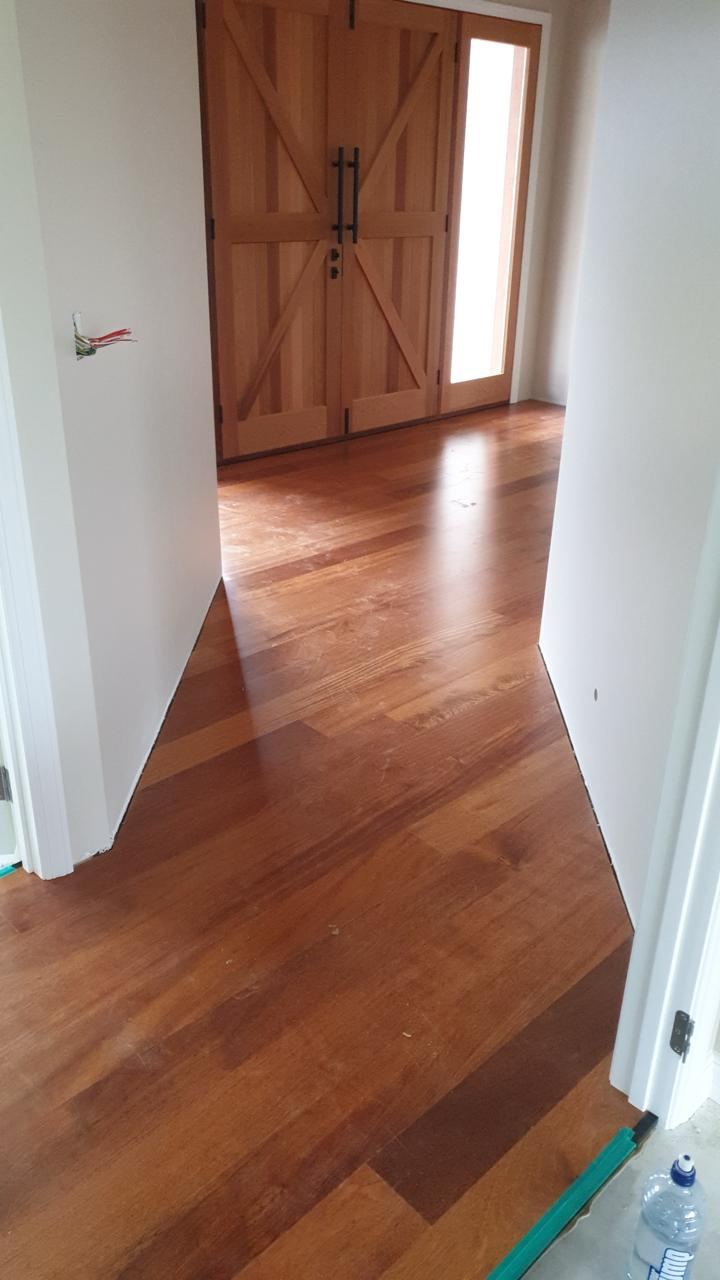 Rich-toned timber flooring running through a home entryway